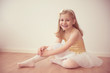 © spass - Smiling pretty ballet girl in white tutu in studio