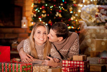 Couple In Love On The Background Of New Year And Christmas Lights Near The Burning Fireplace Consider Christmas Gifts