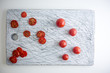 © KOHUT PHOTO - Small red cherry tomatoes spill out of on  old wooden table in r