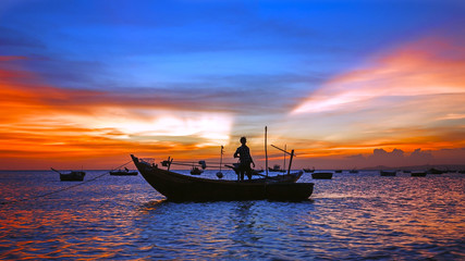 Wall Mural - sea sunset with boat silhouette, man