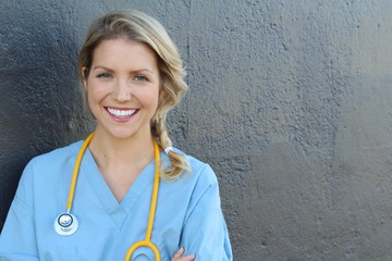 Nurse with long blonde hair and a stethoscope in a uniform smiling at the camera