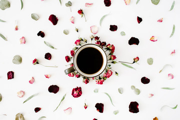 black coffee mug and red rose buds bouquet with eucalyptus on white background. flat lay, top view