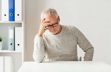 senior man sitting at table
