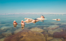 Man Float Meditating In Water Dead Sea. Tourism Recreation, Healthy Lifestyle Concept. Copy Space. Peaceful Meditation