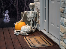 Skeleton And Pumpkins In Doorway For Halloween
