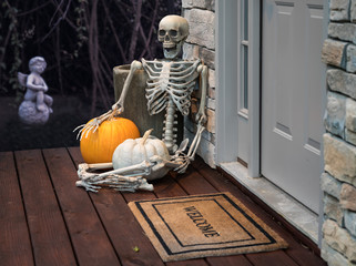 Skeleton and pumpkins in doorway for Halloween