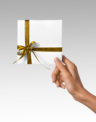 Wall Mural - Isolated Woman Hands holding Holiday Present White Box with Yellow Ribbon on a White Background