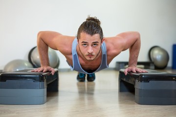 Poster - Portrait of man doing aerobic exercise on stepper