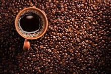 Coffee Cup On Coffee Beans Background