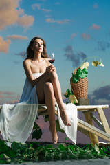 Wall Mural - pretty woman with wine over sky