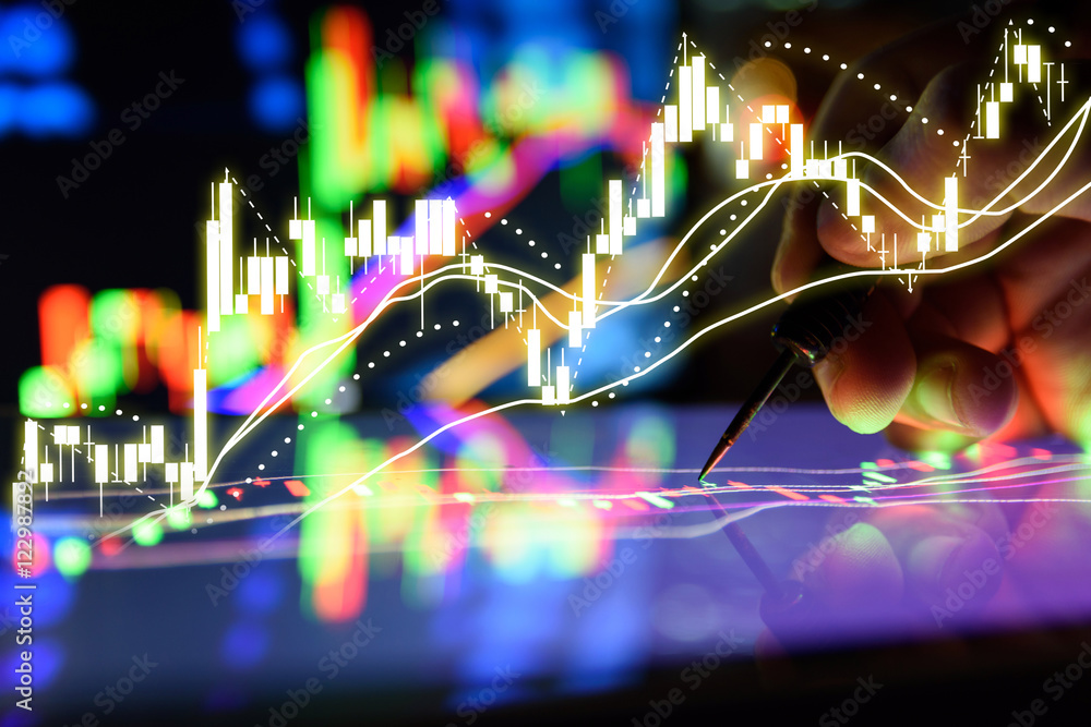 Arrow dart and man finger with Graph Stock market trading tablet screen and laptop's lcd monitor background applied as business and stock concept , forex oil gold trading concept