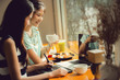 © torwaiphoto - Asian women are freelance work in cafe