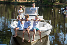 Family Enjoying A Summer Day On A Boat