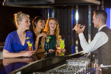 Wall Mural - Waiter interacting with beautiful women