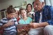Multi-generation family using digital tablet in living room