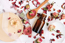 
Essential Rose Oil, Dried Rose Petals, Aroma Dropper Bottle, Wooden Preparation Utensils. Natural Beauty Care. 