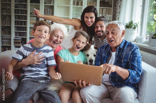 Portrait of happy multi generation using laptop Tablou Canvas