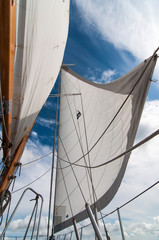  Majestic sails on an authentic sailboat.ith blue skies
