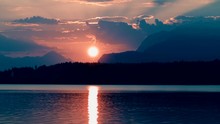 Sunset Behind Mountains On Lakeside