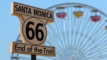 End Of The Route 66 Trail Sign With The Santa Monica Pier Ferris Wheel In The Background