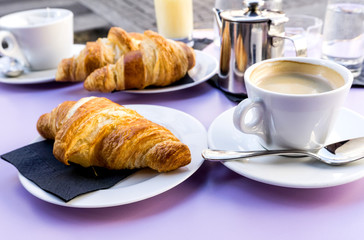 Wall Mural - Breakfast with coffee and croissants on table