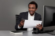© ImageFlow - Happy African businessman with cellphone