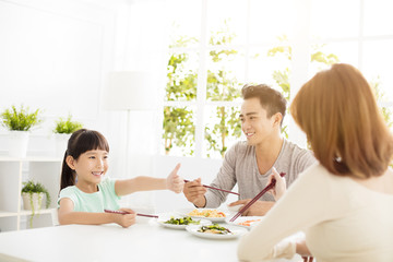 Wall Mural - daughter gives mother  thumbs up for the delicious dinner