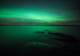 Wall Mural - northern lights over lake in finland