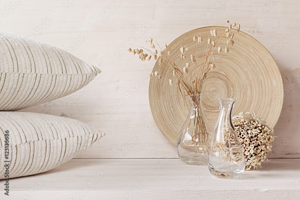 Soft home decor of  glass vase with spikelets and pillows on white wood background. Interior. - obrazy, fototapety, plakaty 