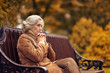 © aletia2011 - Sad elderly woman sitting on a bench in autumn park