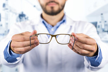 Eyesight Care Concept - Optician Giving New Optical Glasses