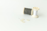 Fototapeta  - Close up of sewing items,Spool of thread, needle and button isolated on white background