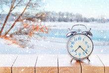 Vintage Retro Alarm Clock In Snowy Weather