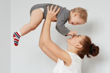 nice shot of happy mother and child on the white background. young attractive woman with bunch of br