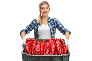 Poster - Female farmer offering a crate full of red peppers