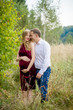© demchyna - Portrait happy and young pregnant couple hugging in nature