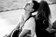 © IVASHstudio - Black and white photo of young man leaning to his woman's back