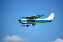 Light General Aviation Aircraft On Final With Cloud Sky Landing Configuration