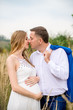 © demchyna - Portrait happy and young pregnant couple hugging in nature