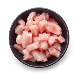 Wall Mural - Raw cut meat chunks in black bowl, from above