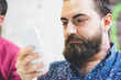 © Connect Images - Bearded young man using cellphone
