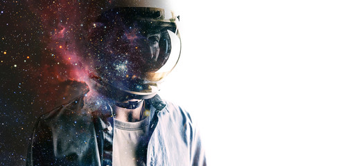 casually dressed sad looking man in a large helmet with bright stars and galaxies projected on the s