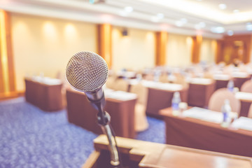 Blur background,close up microphone at podium at Seminar event r