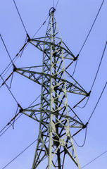 Wall Mural - High voltage electrical overhead lines on blue sky