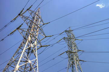 Wall Mural - High voltage electrical overhead lines on blue sky