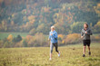 © Halfpoint - Beautiful young couple running in sunny autumn nature.
