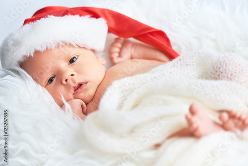 Fototapeta sleeper newborn baby in Christmas Santa cap