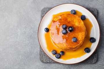 Wall Mural - Pumpkin pancakes with maple syrup and blueberries