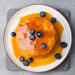 Wall Mural - Pumpkin pancakes with maple syrup Top view