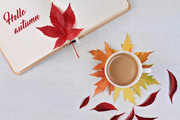 Wall Mural - Inspirational Typographic Quote - Hello Autumn. Composition with cup of coffee, fall leaves. Top view, flat lay